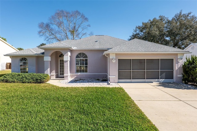 view of front of property with concrete driveway, an attached garage, and stucco siding