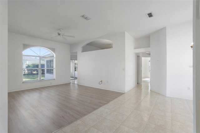 empty room with visible vents, ceiling fan, light wood-style flooring, and baseboards