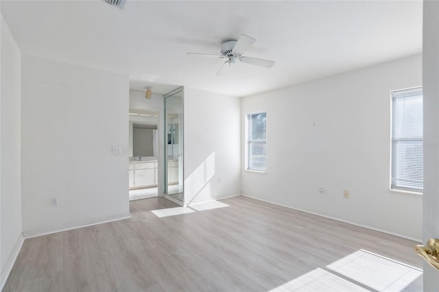 unfurnished bedroom featuring baseboards, a ceiling fan, and light wood-style floors