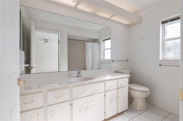 bathroom featuring toilet, a shower with shower curtain, vanity, and tile patterned floors