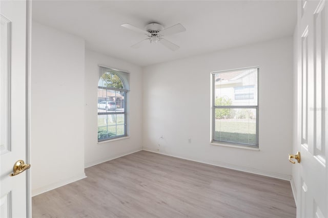 empty room with light wood-type flooring, ceiling fan, and baseboards