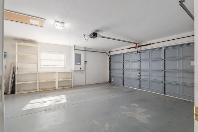 garage featuring electric panel and a garage door opener