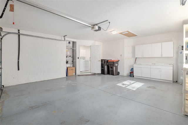 garage with a garage door opener and washer / clothes dryer