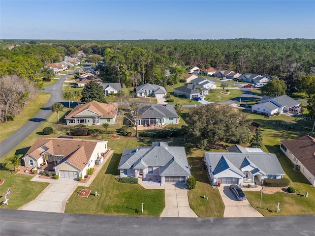 bird's eye view featuring a wooded view and a residential view