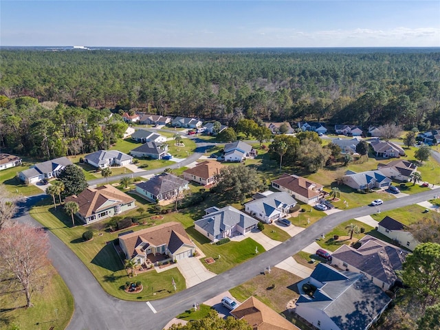 drone / aerial view with a residential view and a view of trees