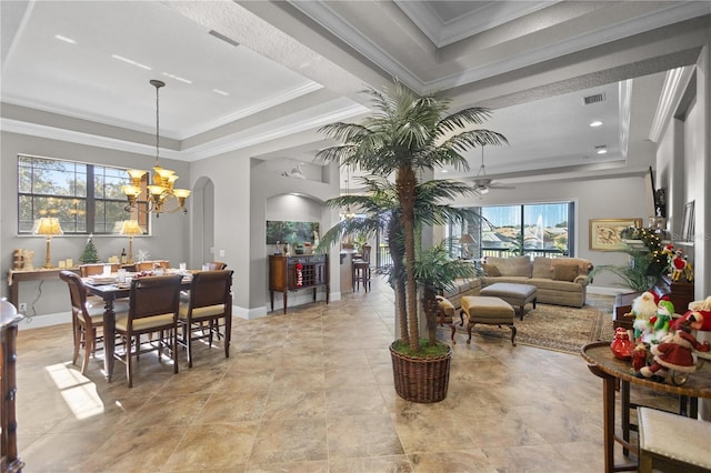 interior space with a notable chandelier, ornamental molding, and a raised ceiling