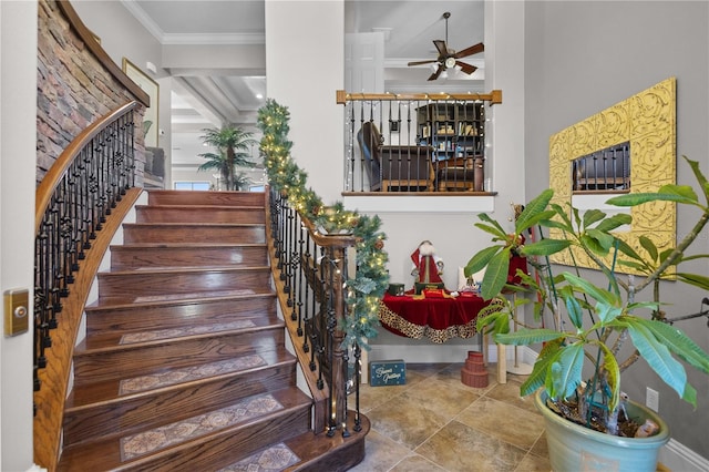 stairway featuring ceiling fan and crown molding