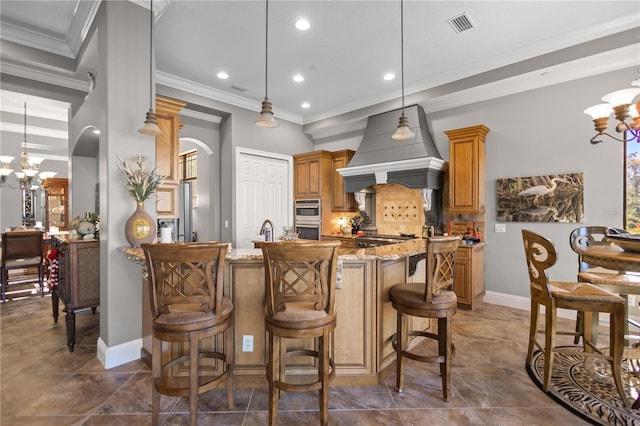 kitchen with custom exhaust hood, an inviting chandelier, light stone countertops, and pendant lighting