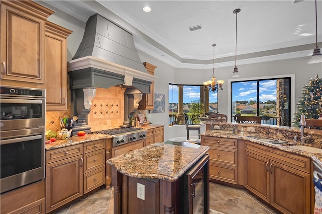 kitchen featuring stainless steel appliances, hanging light fixtures, wine cooler, premium range hood, and sink