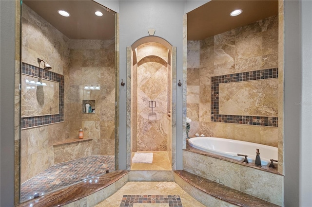 bathroom featuring shower with separate bathtub