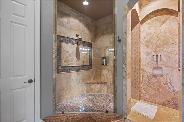 bathroom featuring a shower with shower door