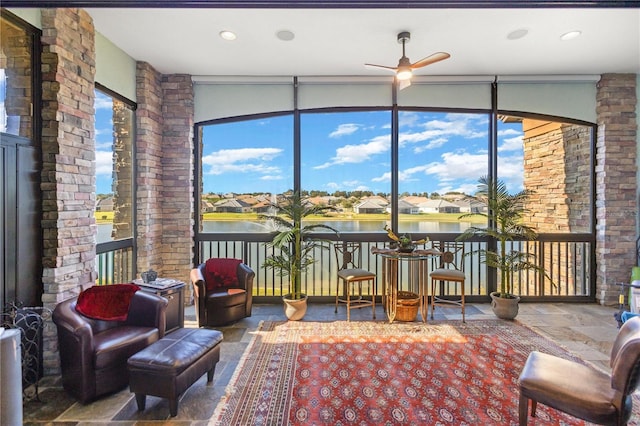 sunroom / solarium featuring ceiling fan