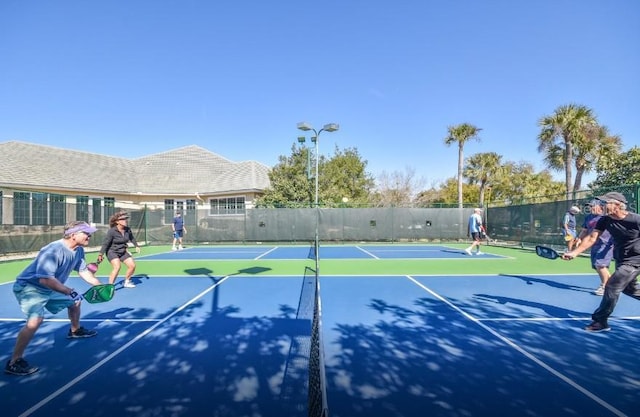 view of tennis court featuring basketball hoop