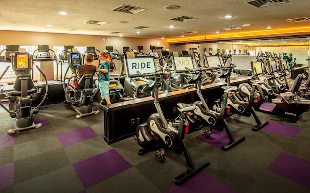 workout area featuring a textured ceiling