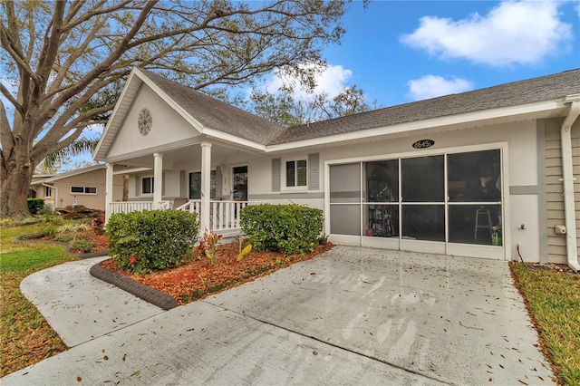 view of front of property with a shingled roof and covered porch