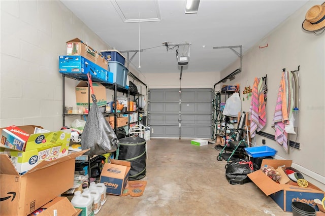 garage featuring a garage door opener and concrete block wall