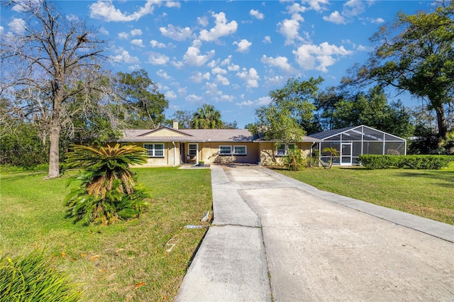 ranch-style home featuring a lanai and a front lawn