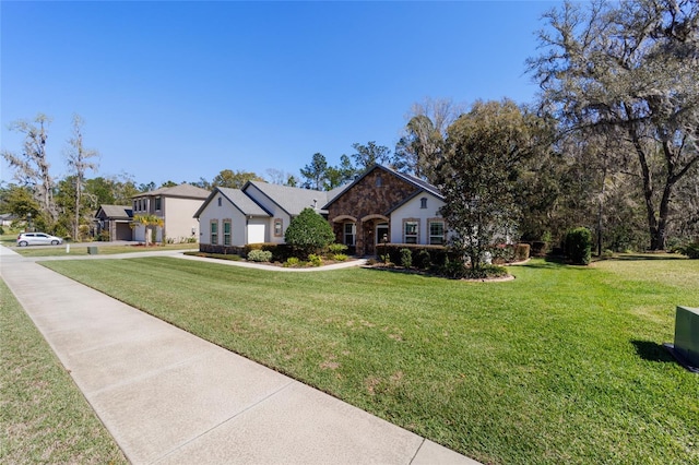 view of front of house with a front yard and stone siding