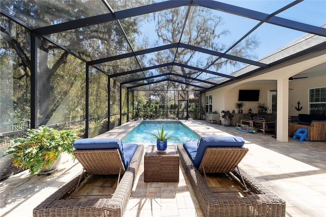 outdoor pool featuring a patio and glass enclosure