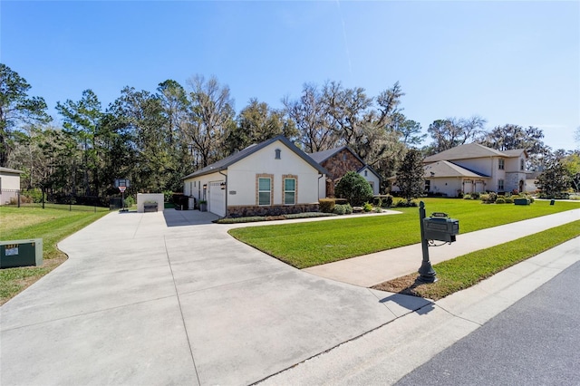 view of front facade featuring driveway, a front yard, and a garage
