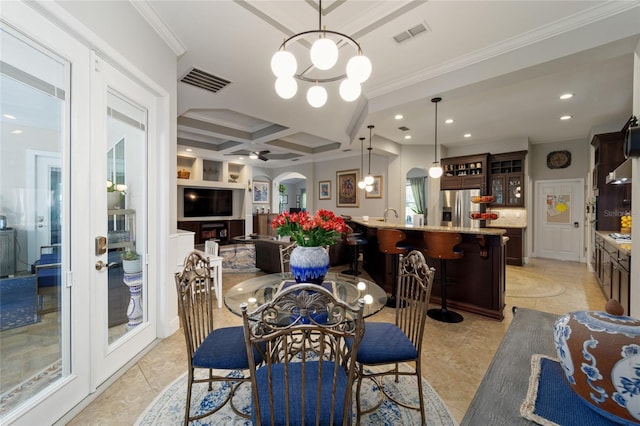 dining space with visible vents, recessed lighting, ornamental molding, and arched walkways