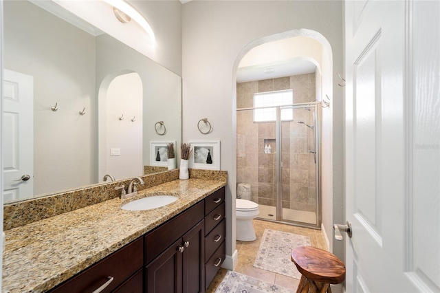 full bathroom with a shower stall, toilet, and vanity