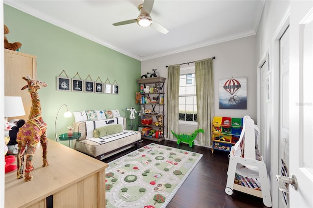 bedroom with a ceiling fan, crown molding, dark wood-style floors, and a closet