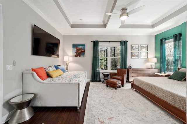 bedroom featuring crown molding, a ceiling fan, wood finished floors, and baseboards