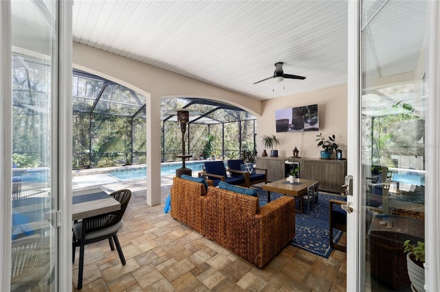sunroom / solarium with a pool, an outdoor living space, and a ceiling fan