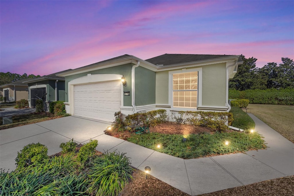 6780 SW 91st Cir, Ocala, FL 34481 - ranch-style house with a garage, concrete driveway, and stucco siding