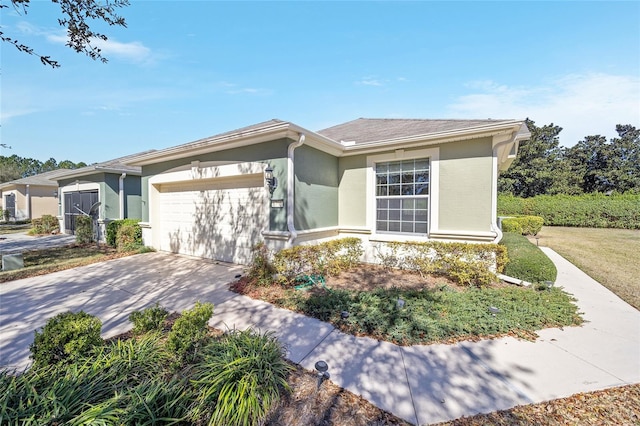 ranch-style home with a garage, concrete driveway, and stucco siding