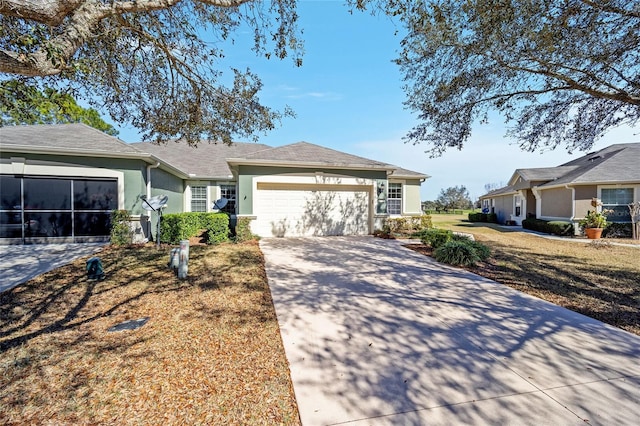 single story home featuring an attached garage, a front yard, concrete driveway, and stucco siding