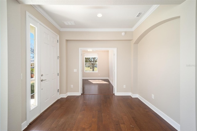 foyer with dark wood-style floors, baseboards, visible vents, and arched walkways