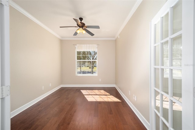 empty room with crown molding, dark wood finished floors, and baseboards