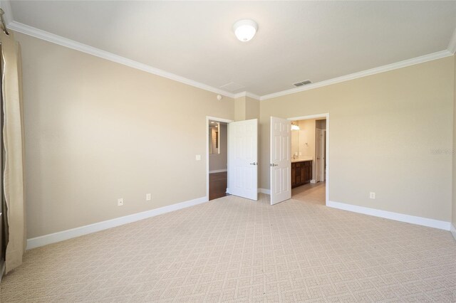 unfurnished bedroom with crown molding, light carpet, visible vents, and baseboards