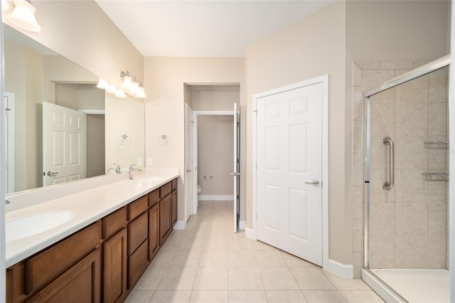 bathroom featuring a stall shower, a sink, and toilet