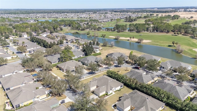 bird's eye view with a water view, view of golf course, and a residential view