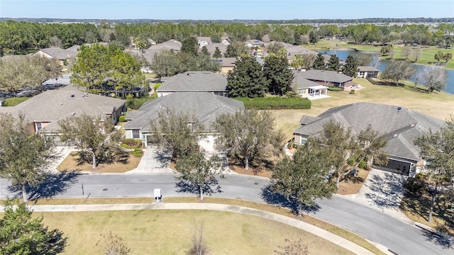 birds eye view of property featuring a water view and a residential view