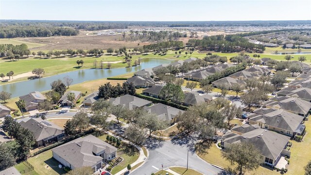 birds eye view of property featuring golf course view, a water view, and a residential view