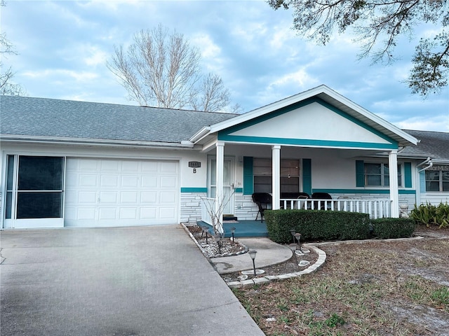 single story home featuring covered porch and a garage