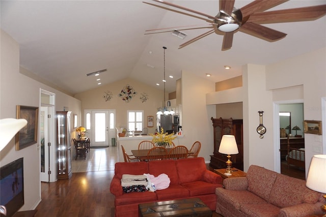 living room featuring wood finished floors, visible vents, a ceiling fan, french doors, and a glass covered fireplace