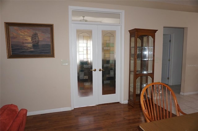 doorway to outside with dark wood-style floors, baseboards, and french doors