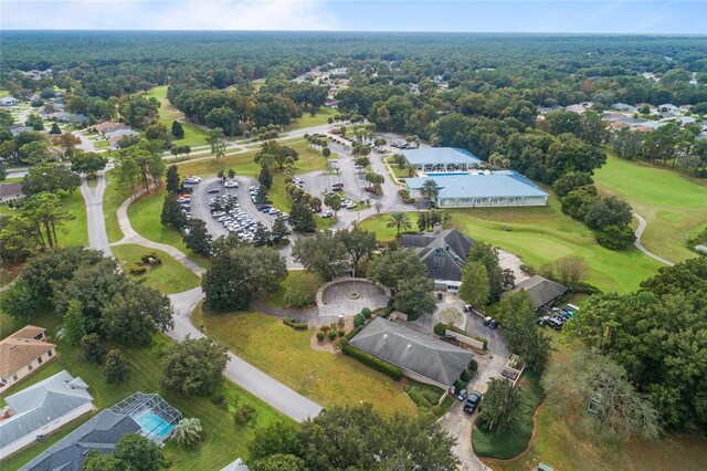 aerial view of property's location with a golf club and nearby suburban area