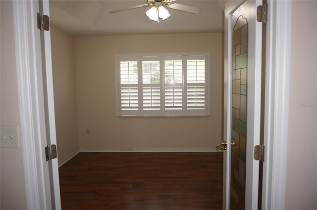 spare room with wood finished floors, ceiling fan, and baseboards