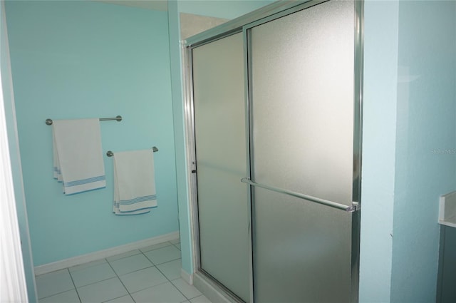 full bathroom featuring a shower stall, tile patterned flooring, and baseboards
