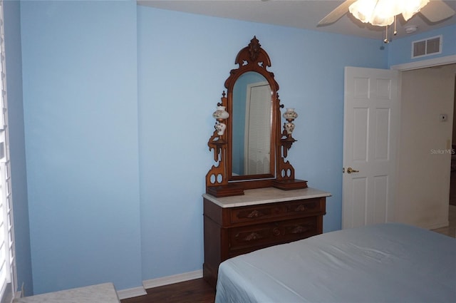 bedroom featuring dark wood-type flooring, baseboards, and ceiling fan
