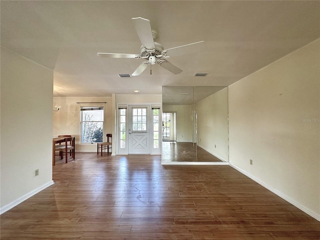 unfurnished room with dark wood-type flooring and ceiling fan