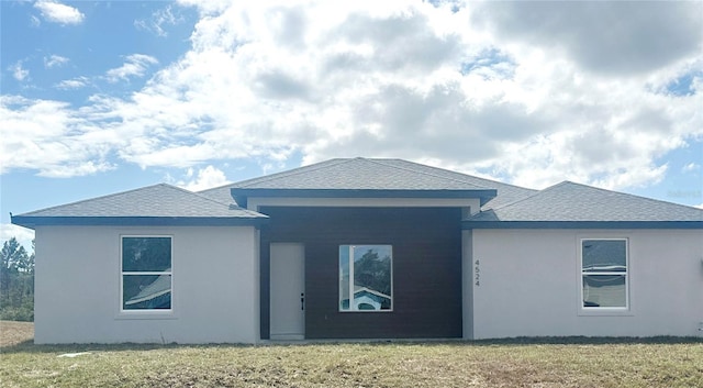 rear view of house with a lawn