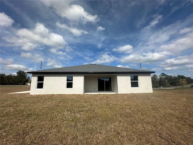 rear view of house with a lawn