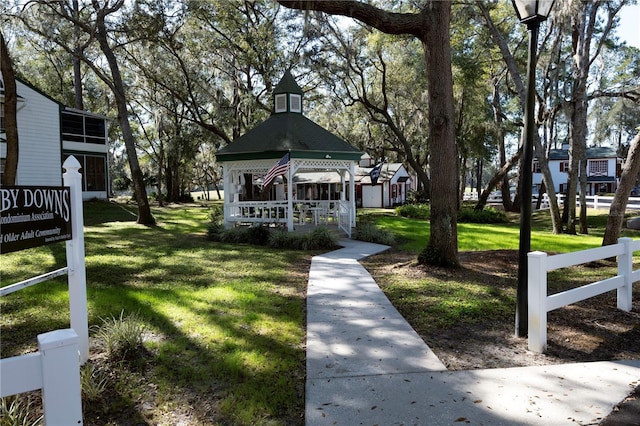 view of home's community with a lawn and a gazebo